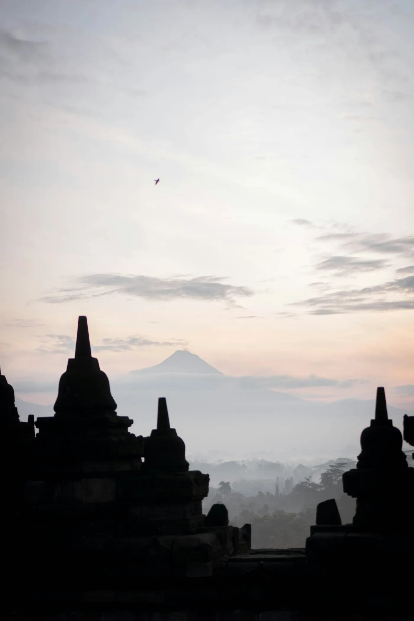 Siluet Candi Borobudur di Magelang saat matahari terbit dengan latar pegunungan
